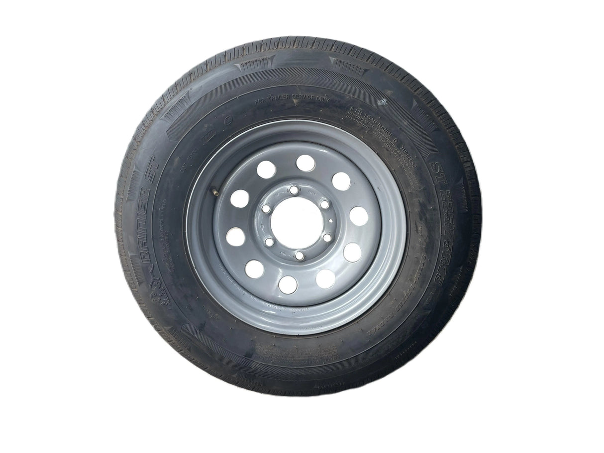 Radial trailer tire with steel rim, black sidewall, isolated on white background