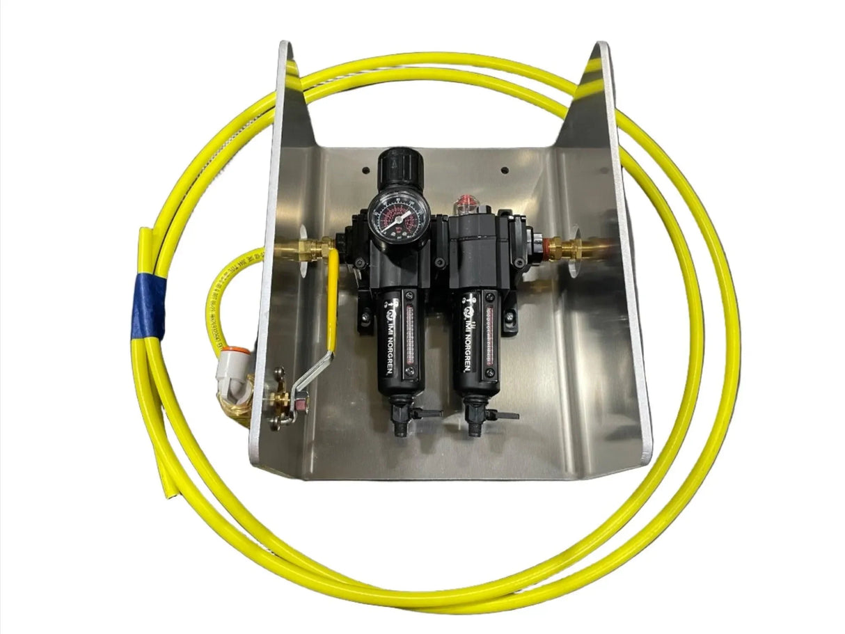 Compressed air regulator and filter kit with gauge and yellow hose on metal mounting plate