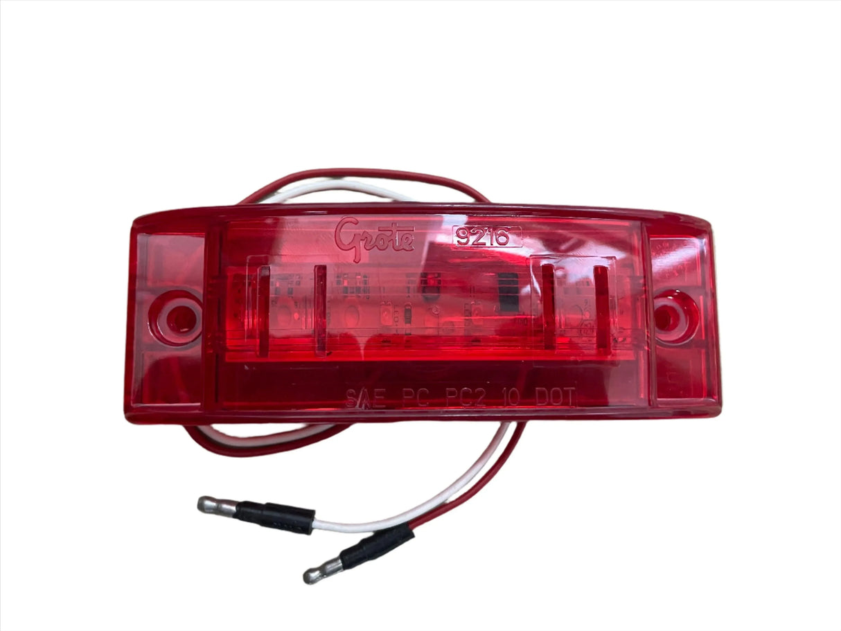 Grote 9216 red LED trailer light with white and red wires on white background
