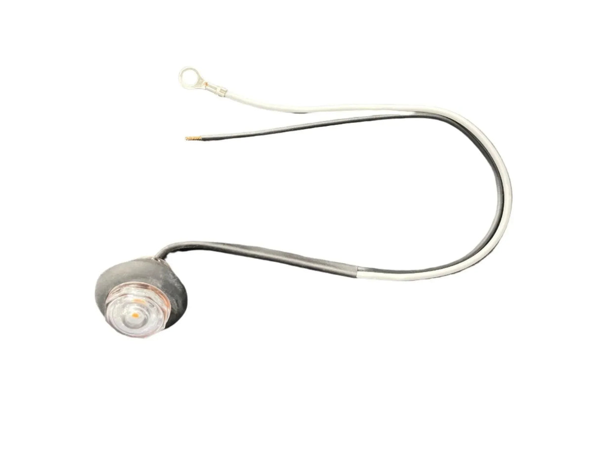 LED indicator light with clear lens and attached black and white wires on white background
