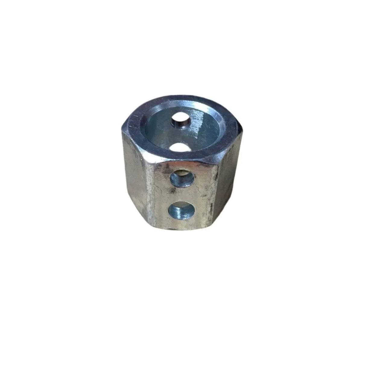 Hexagonal metal coupling nut with drilled holes on a white background
