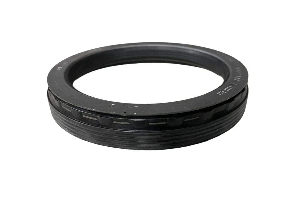Black rubber automotive oil seal gasket on white background