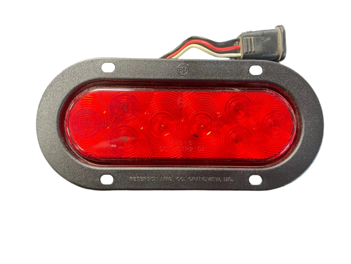 Red oval LED trailer tail light with six diodes and attached wiring harness