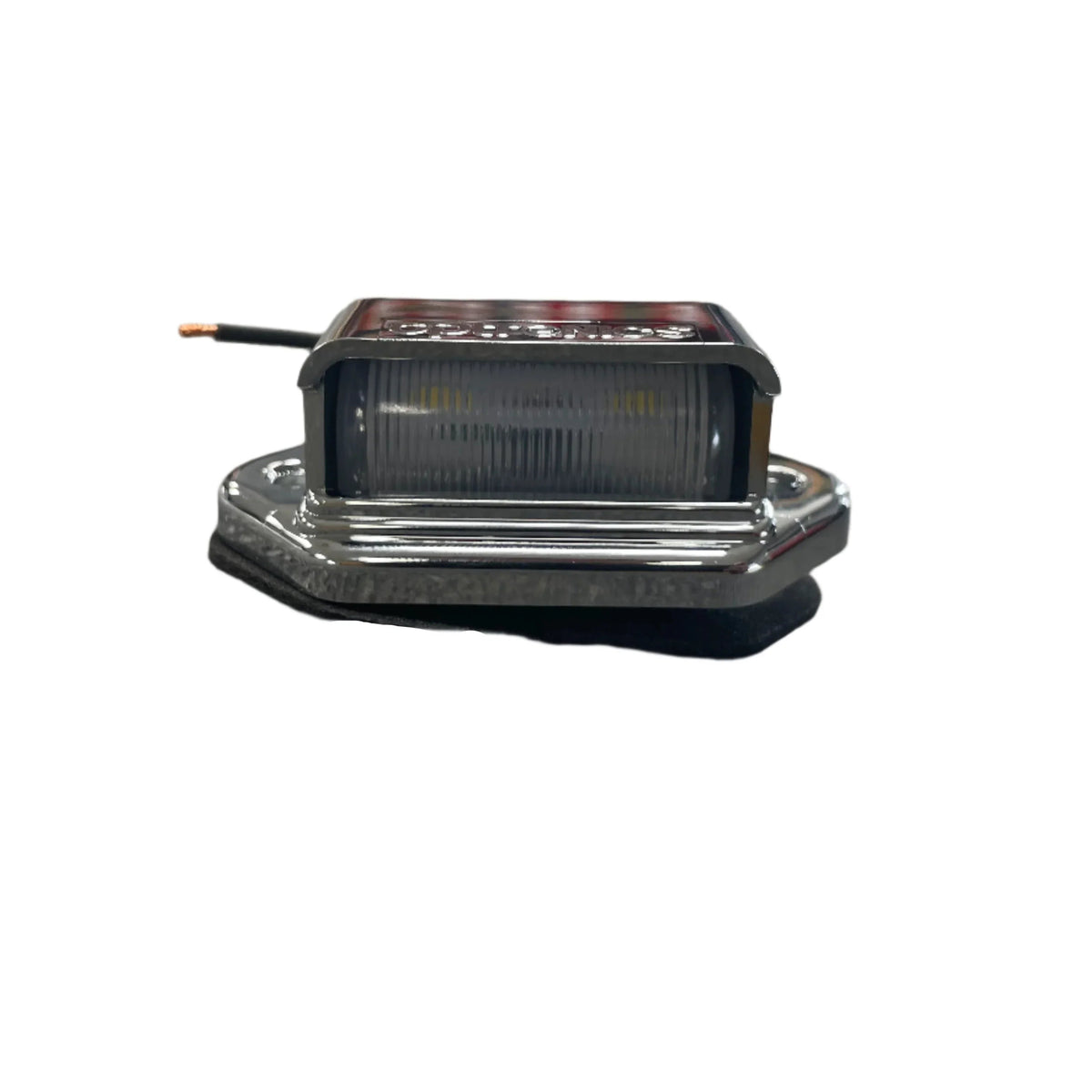 Sure-Trac LED license plate light, chrome housing with black wire, on white background
