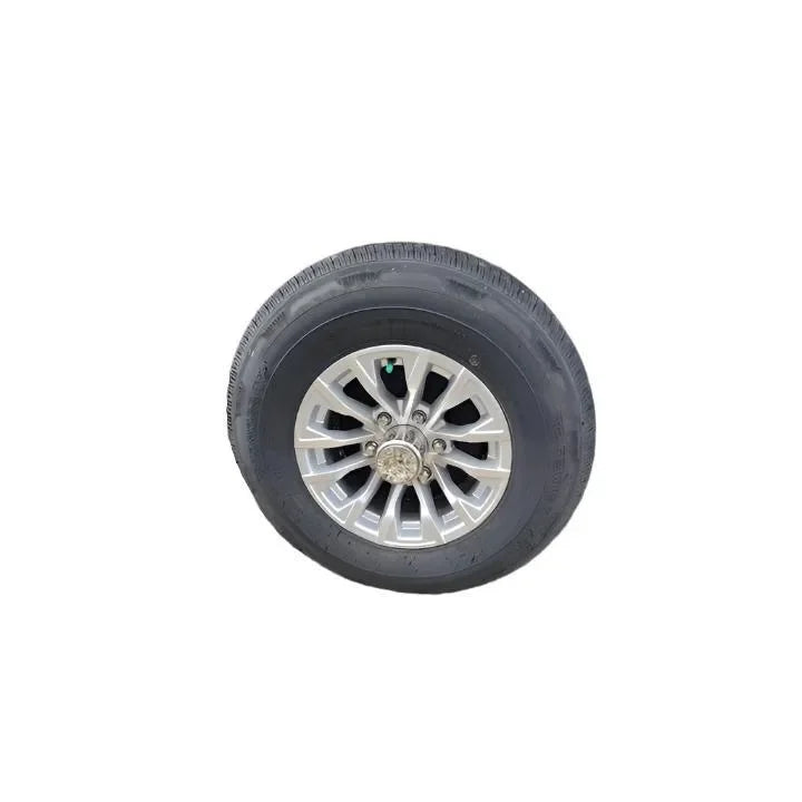 Trailer tire with silver alloy wheel on white background