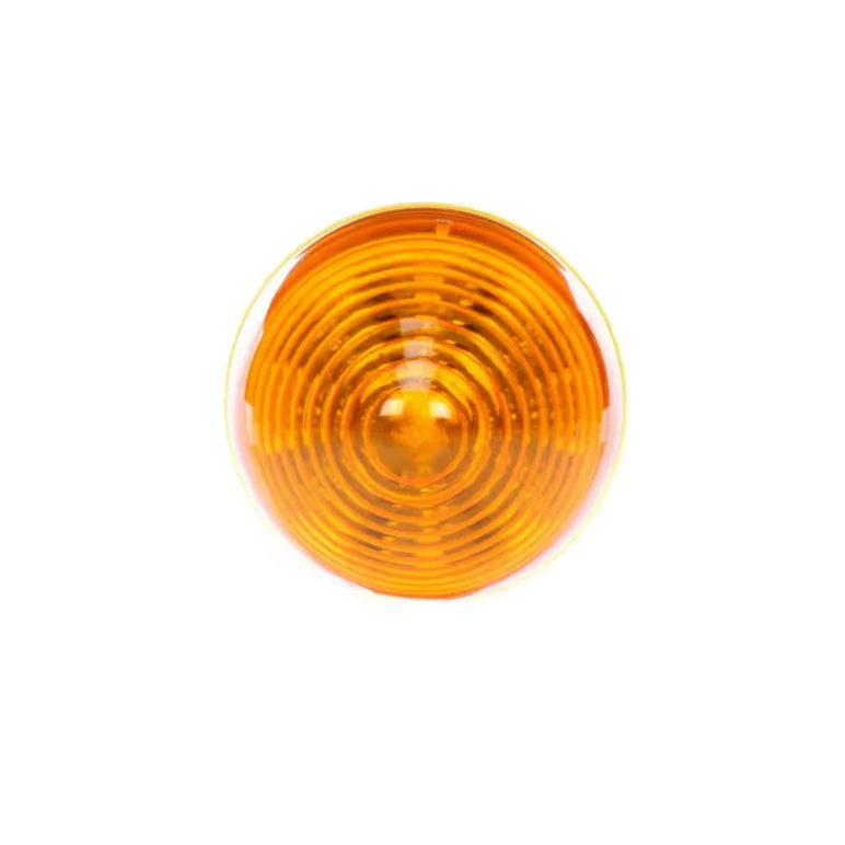 Round amber motorcycle turn signal lens on white background