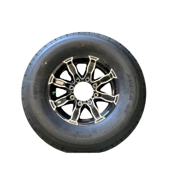 Black car tire with alloy wheel rim on white background