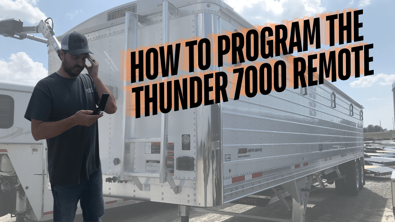 Man using Thunder 7000 remote by aluminum grain trailer, with programming guide text overlay