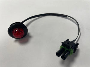 Red LED indicator light with wiring harness and black connector on white background