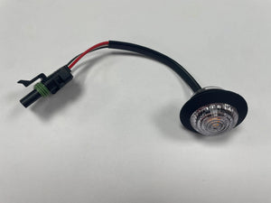 LED round marker light with black wiring and connector on a white background