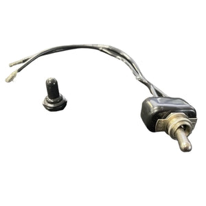 Metal toggle switch with wires and a black rubber cover on a white background