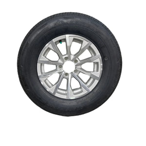 Trailer tire with alloy wheel rim on white background