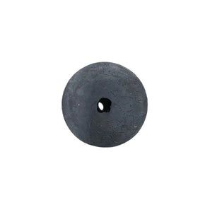 Antique black stone disc with central hole and weathered surface on white background