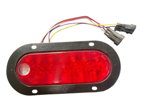 Oval red LED trailer tail light with black mounting plate and attached wiring harness