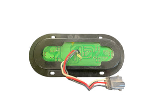 Oval green LED circuit board with wires and connector on a black mounting plate