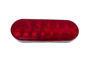 Red oval LED trailer tail light with six round sections on white background