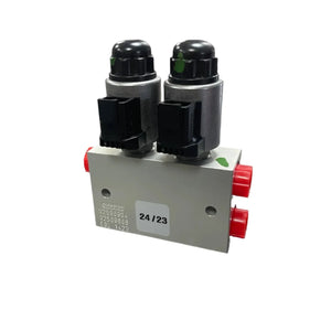 Dual solenoid hydraulic valve block with connectors and red caps on ports