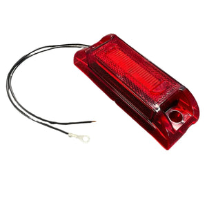 Red rectangular LED trailer tail light with attached black wires on white background