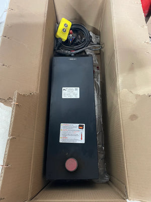 Hydraulic power unit with control cables and yellow remote in cardboard box shipping packaging.