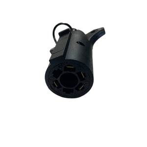 Black 7-way trailer plug connector with metal contacts on white background
