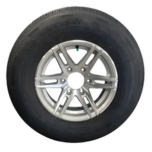 Radial trailer tire with alloy wheel on white background, showing Rainier ST branding.