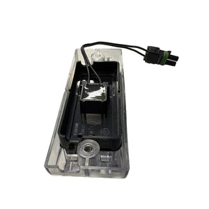 Clear plastic automotive LED light with black wiring and connector, isolated on white background