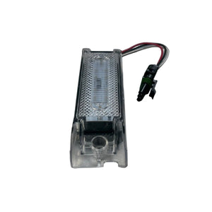 Clear LED license plate light with wiring harness for vehicles on white background