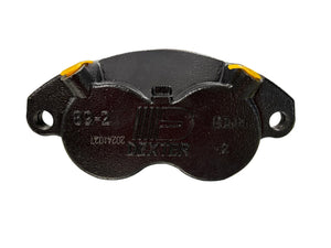 Dexter black trailer brake caliper with yellow accents on a white background