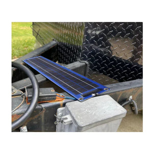 Flexible solar panel on utility trailer with diamond plate siding outdoors
