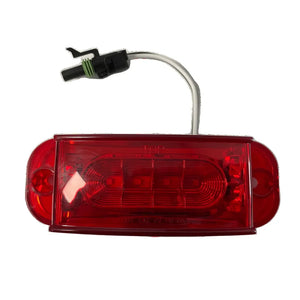 Red LED trailer tail light with connector and white wiring, isolated on white background