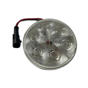 Round LED tail light with clear lens, wiring harness, and black connector plug